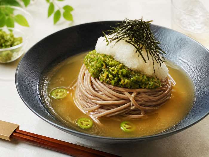 Korean spicy cold buckwheat noodles with green chile yuja relish, grated radish, and seaweed
